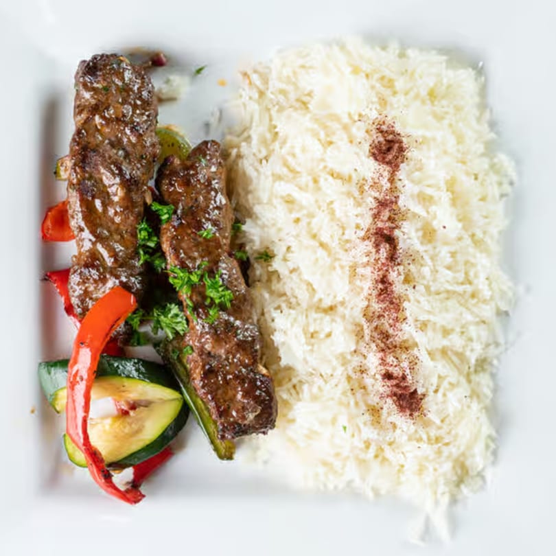 Jasmine Grill's Mediterranean beef kebabs with grilled vegetables and a side of rice.